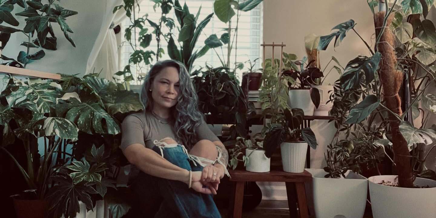 Jennifer Moyer of Rare Form Plants seated among her houseplant collection
